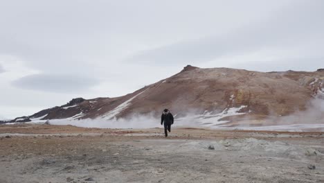 Man-walk-around-Myvatn-geothermal-area-and-suddenly-start-running,-Iceland