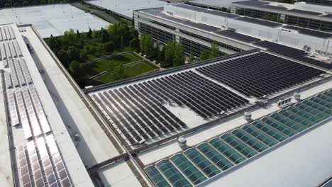 Solar-panels-installed-in-a-corporate-office-complex-parking-lot-and-solar-panels-on-the-office-complex-buildings