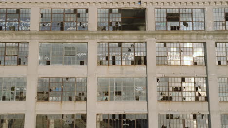 aerial view of the exterior of an abandoned warehouse at sunset.