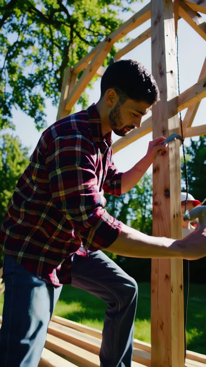 Man Constructing a Wooden Structure in a Garden