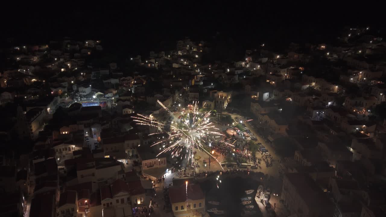 Beautiful footage of night fireworks over Symi harbor in Greece with light reflections on calm Aegean waters. Filmed on Easter 2025-04-20.