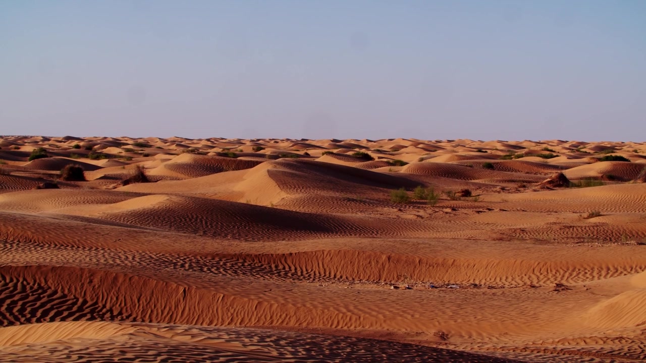 Cinematic drone flight over the rugged desert mountains and rocky terrain of Tunisia. Dramatic landscape where the Sahara sand meets the arid mountain ranges of North Africa at golden hour