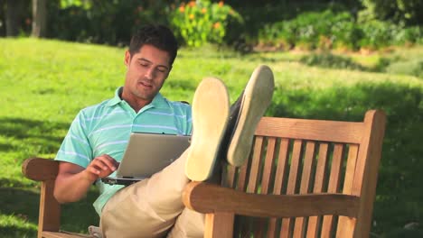 Man-using-laptop-outdoors
