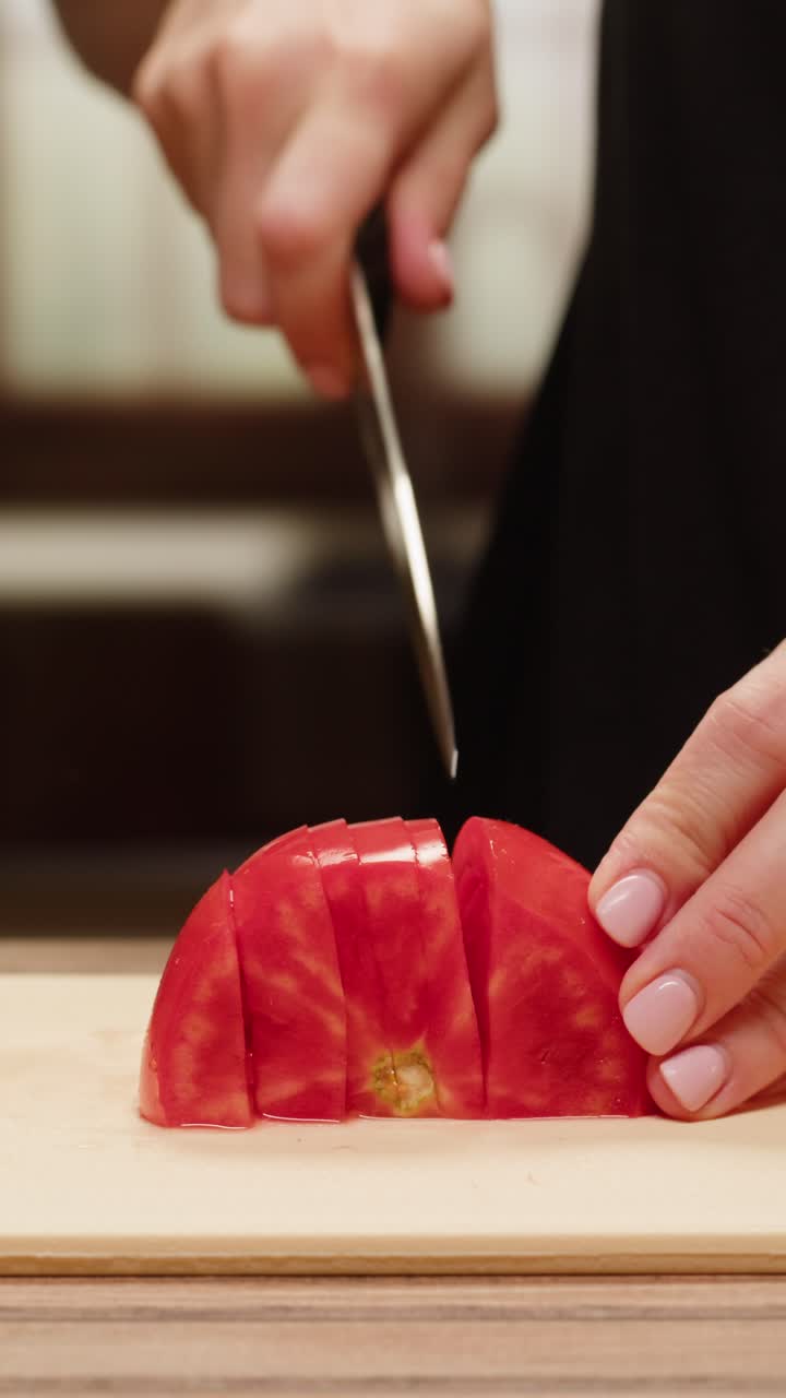 Slicing a tomato on a cutting board