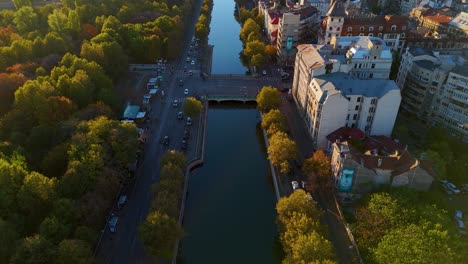 Aerial-Reveal-Over-Dambovita-River-at-Sunset,-Autumn-Vibes,-Izvor-District,-Bucharest,-Romania