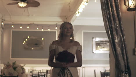 model bride walking with roses indoors