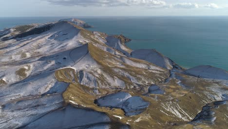 snowy mountainous coastline aerial view