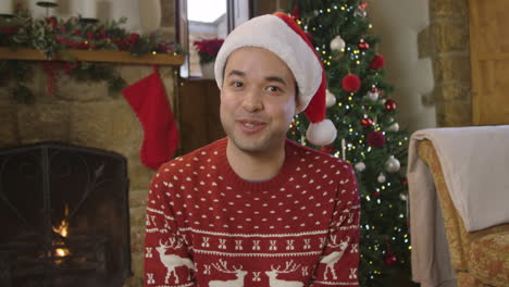 Young-Man-Talking-Directly-to-Camera-During-a-Christmas-Video-Call