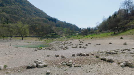 Drone-Pullback-Over-Mountains-And-Tenno-Lake-In-Trentino-Alto-Adige,-Lombardia-Italy