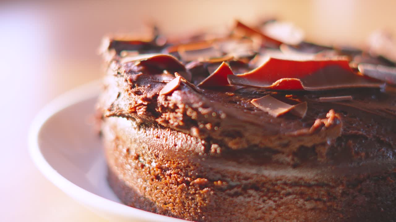 Luxurious Milk Chocolate Cake Dessert with Camera Slowly Rotating in Natural Lighting in Kitchen Setting. Served at Birthday Parties or Afternoon Tea. Food Photography.