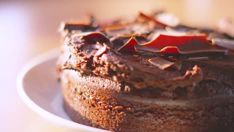 luxurious milk chocolate cake dessert with camera slowly rotating in natural lighting in kitchen setting. served at birthday parties or afternoon tea. food photography.