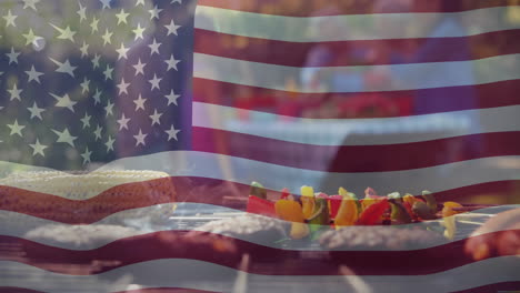 animation of american flag over food on barbecue and diverse friends celebrating outdoors