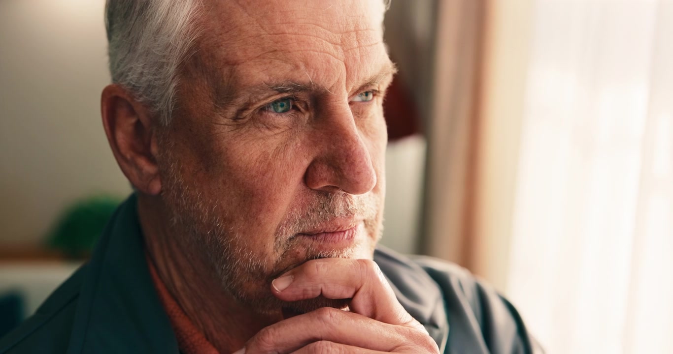 Thoughtful Senior Man Looking Out Window