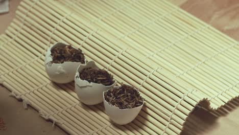 filling eggshells with soil mix to be use as a seed starter container that shows a creative zero waste gardening idea