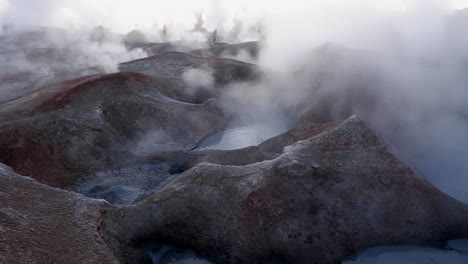 mud pots boil, steam at sol de manana geysers on bolivia altiplano