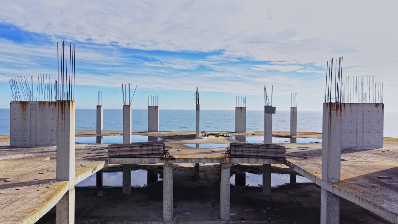 Views from an unfinished structure along the coast at sunset