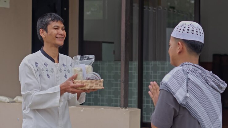 Smiling Muslim man receives basket of rice and food as Zakat donation during Ramadan