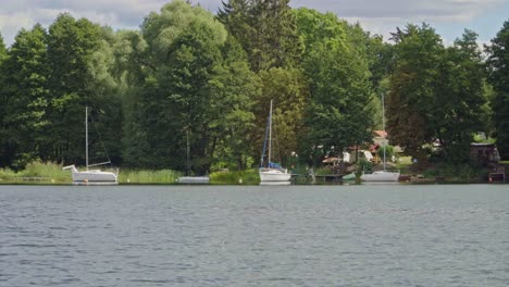 moored yachts on lake moved by large water current