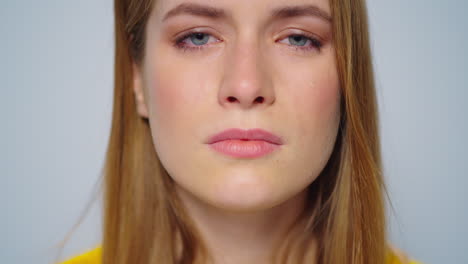 Portrait-of-upset-woman-looking-at-camera-in-studio.Unhappy-girl-crying.