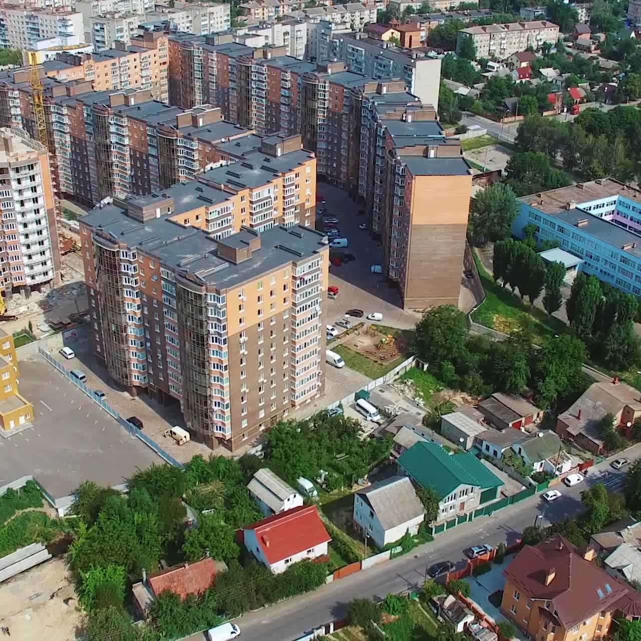 Construction site in the city. Modern district build in the downtown. New residential area on the urban background. Aerial view.