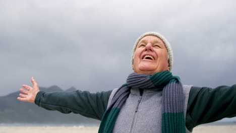 happy senior man standing on the beach