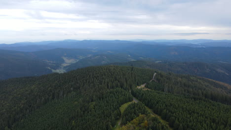 aerial view of the top of the hills with the forest lying below and lots of smaller peaks and nature