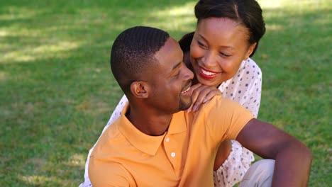 Cute-couple-sitting-on-the-grass