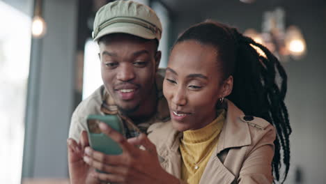 couple, kiss or online on smartphone in restaurant