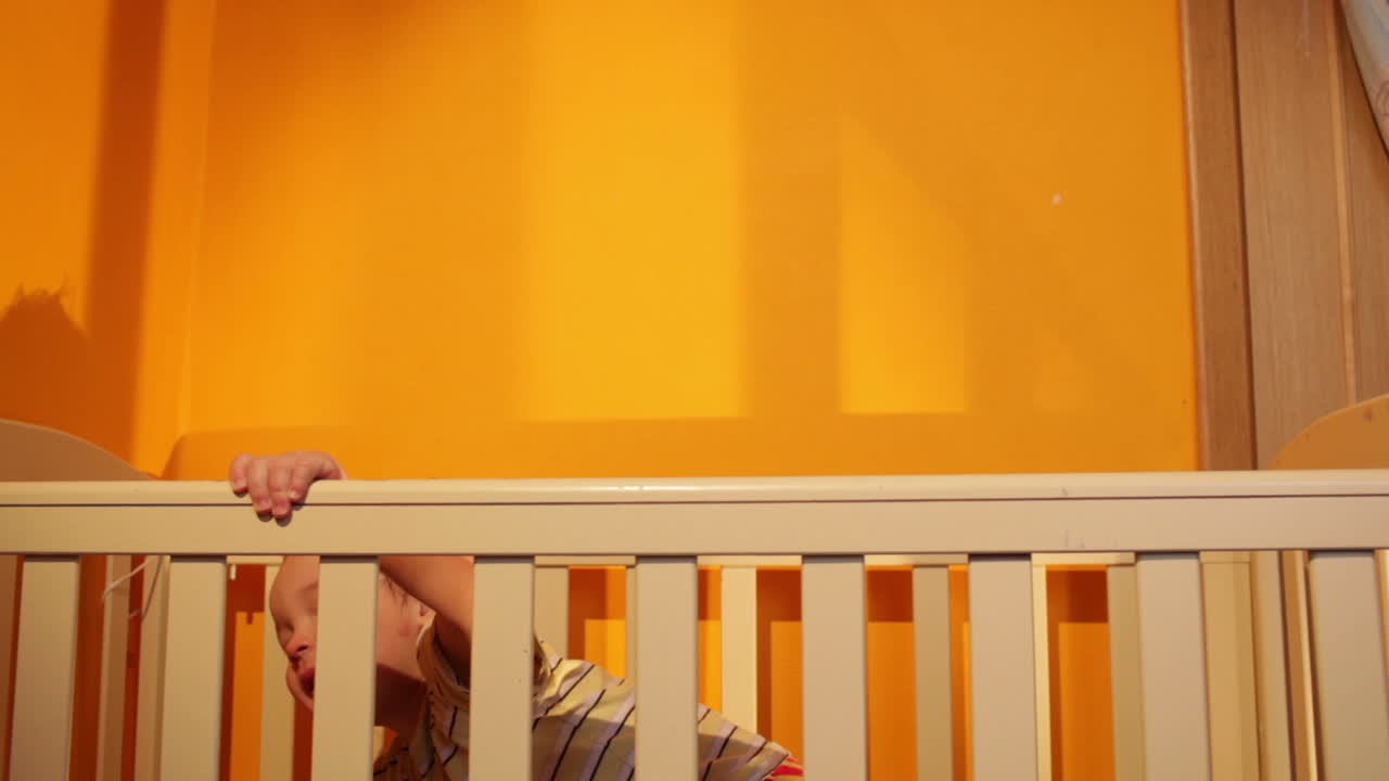 Boy plays with balloon in the playpen