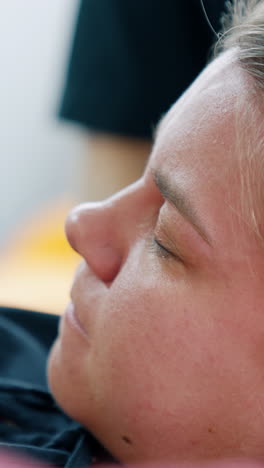 face of a woman during labor. pregnant lady closed her eyes feeling pain. close up portrait. vertical video