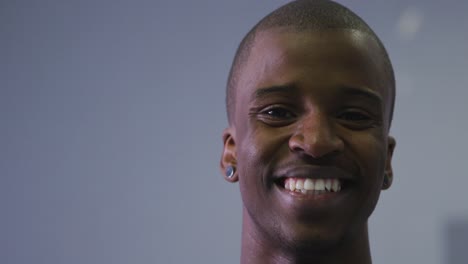 Portrait-of-a-mixed-race-modern-male-dancer-looking-at-the-camera