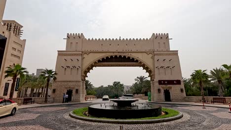 a car approaches the grand entrance archway