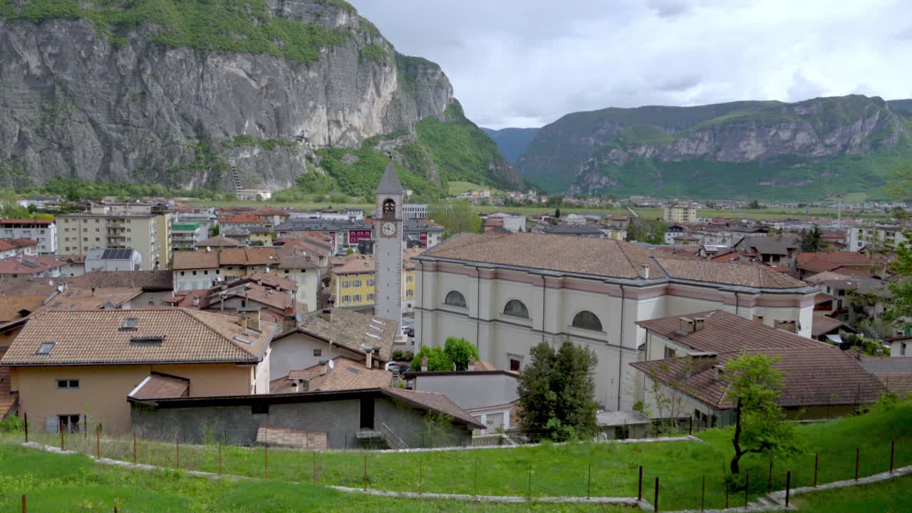 View over the village of Mezzolombardo towards Mezzocorona, Trentino, Italy on a cloudy day in April.