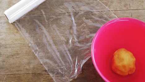 dough ball in bowl with wrapping paper 4k