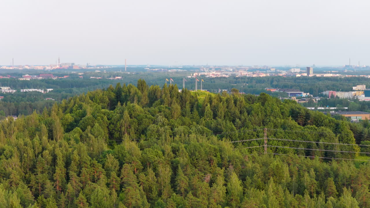 Aerial view orbiting the Malminkartanonhuippu mountain, summer sunset in Helsinki