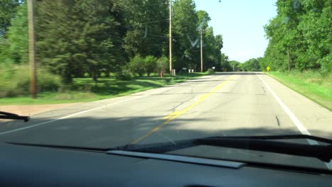 passenger view of driving on a summer day