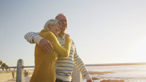 Senior-couple-walking-alongside-beach