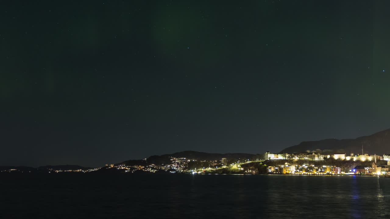 Aurora Borealis appearing and dancing over Nordnes in downtown Bergen, Norway
