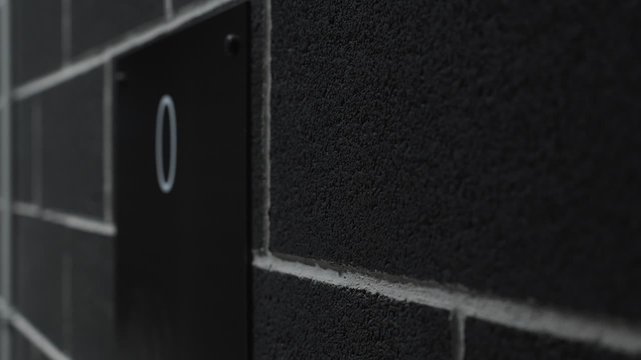 revealing shot of a ground floor sign on the wall beside an elevator