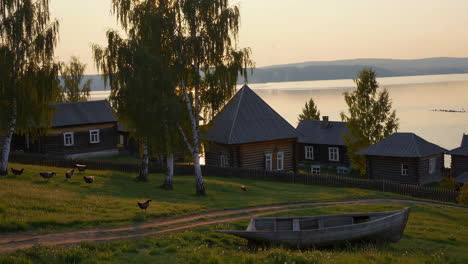 sunrise over a siberian village by the lake