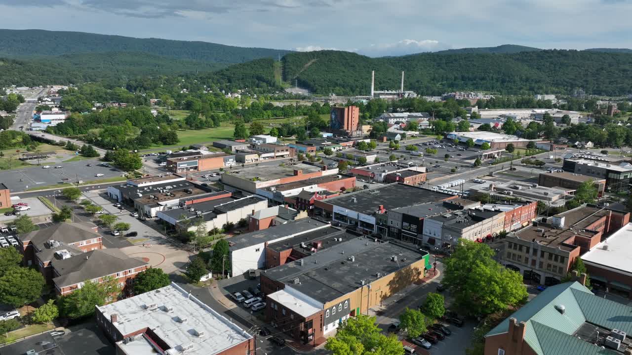 Aerial view of Waynesboro, Virginia, with historic downtown, brick buildings and Blue Ridge Mountains in background. Scenic small American town on sunny summer day in USA. Wide shot