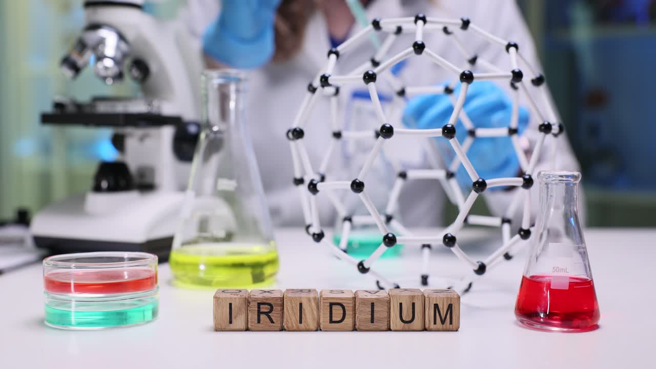 Chemist carefully adds liquid into test tube using pipette