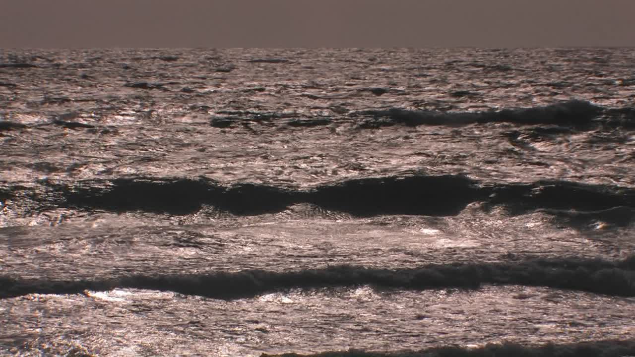 고르지 못한 파도가 계속해서 부서지고 해안으로 밀려옵니다 1