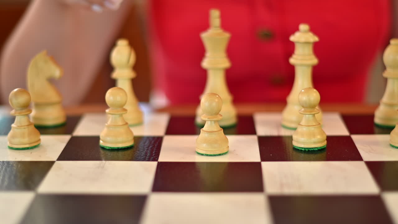 Woman in red shirt playing chess in daylight