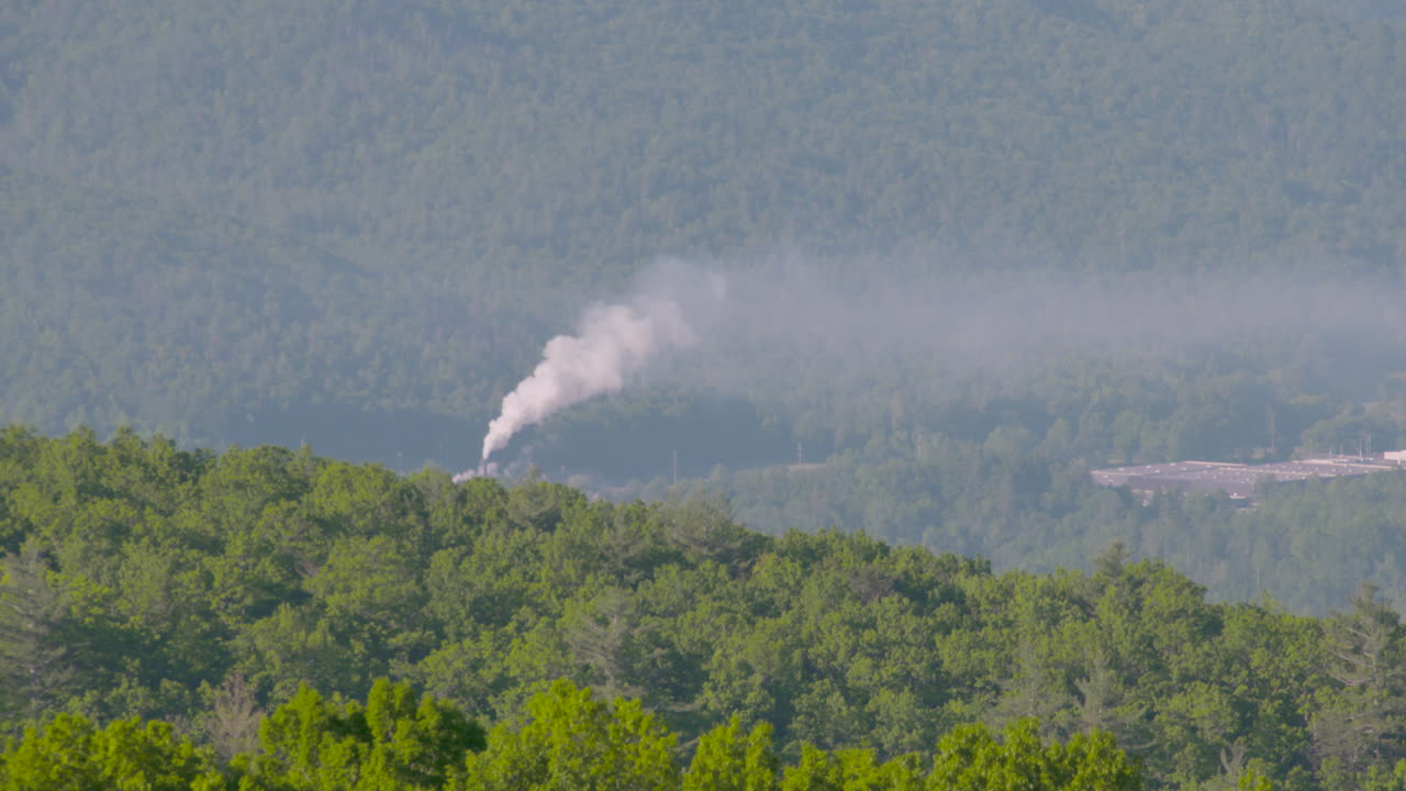 Smoke stack pollution in green mountains