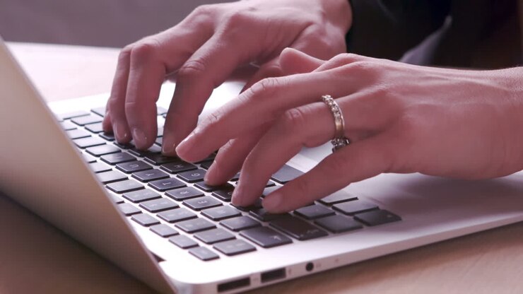 Businesswoman typing on laptops keyboard