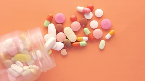 pastillas y cápsulas variadas derramadas de un recipiente