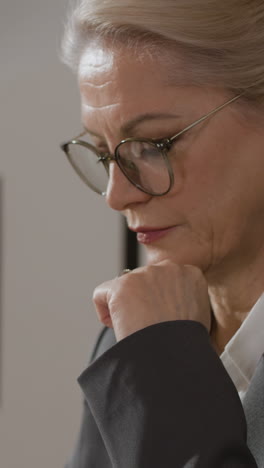 businesswoman thinking with notebook and glasses