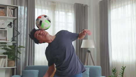 asian man show skill with soccer ball in living room, soccer freestyle