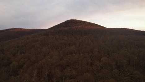 aerial drone footage of a red and gold colored sunset golden hour in the appalachian mountains during autumn
